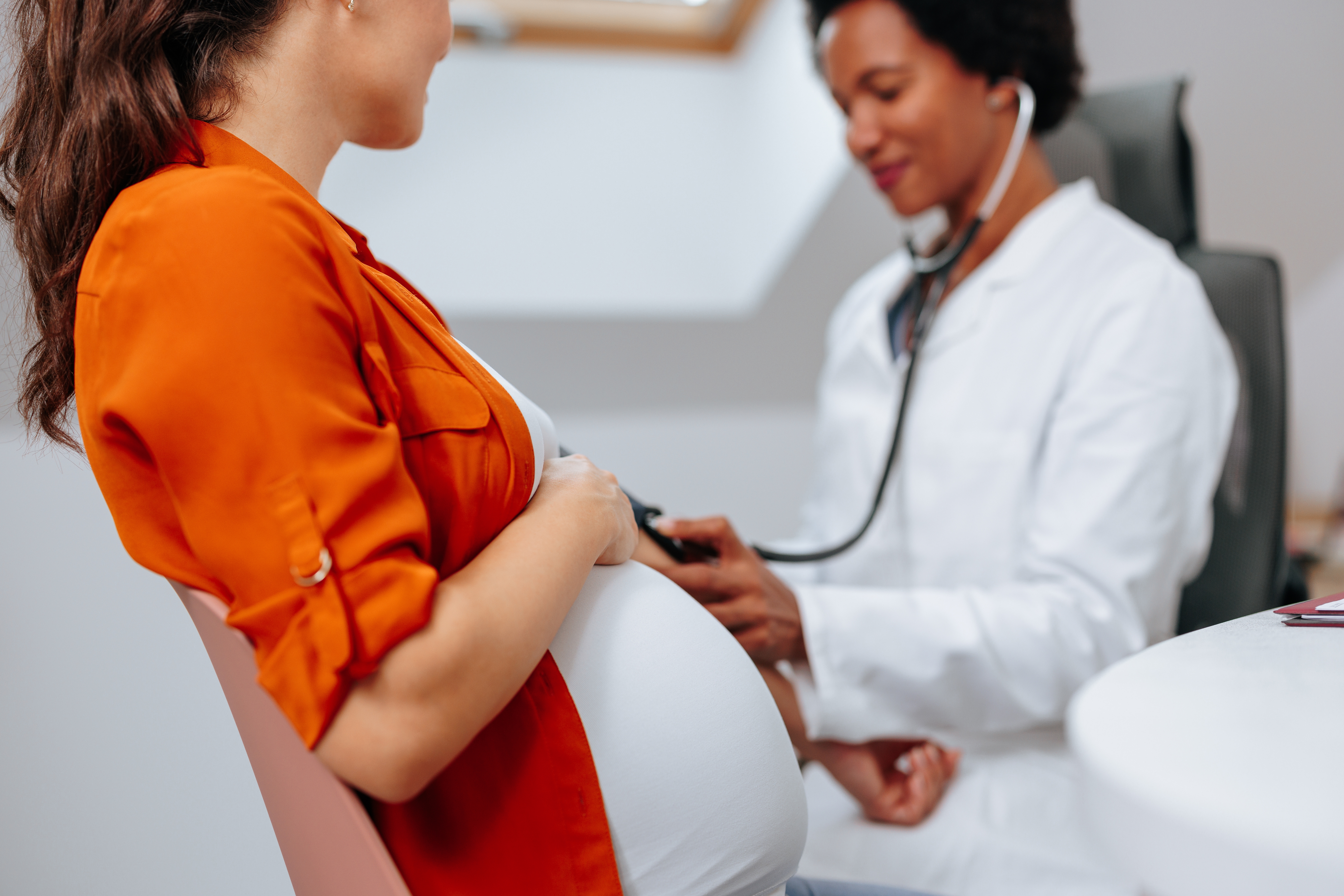 African American midwife giving care to a pregnant patient